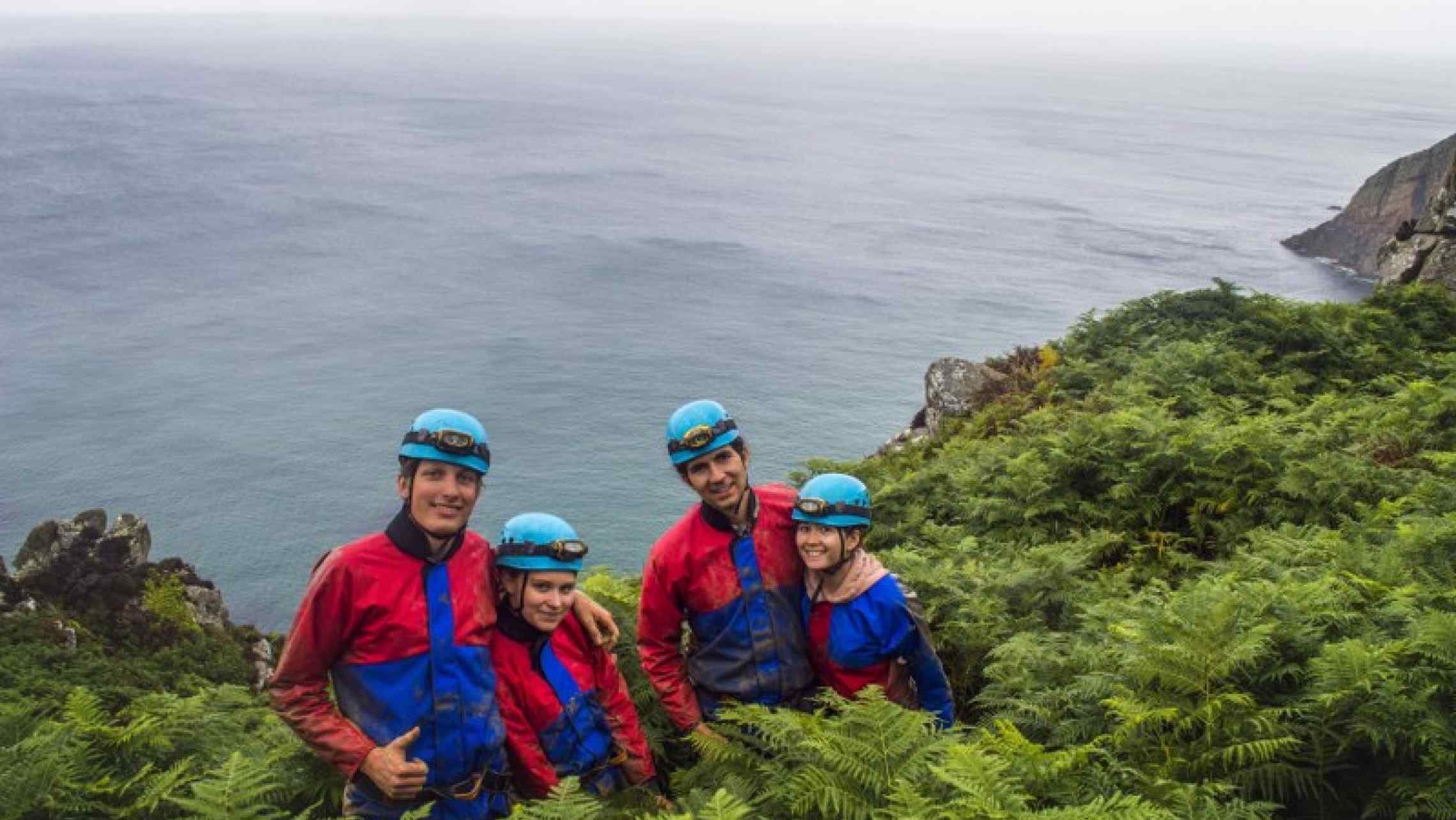 Mine Explorers emerging from an ancient tin mine on the cliffs of Cornwall.