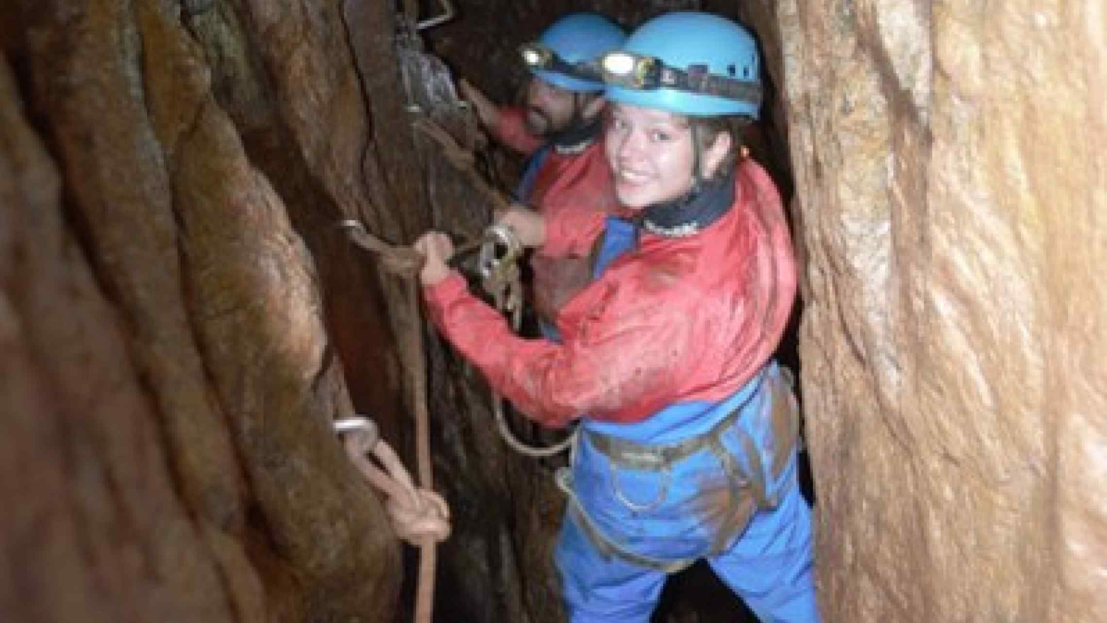 Mine explorers traversing the space walk deep in a Cornish mine near St. Just, Penzance, and St. Ives.