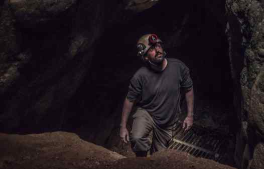 Mine explorer exploring a tin mine in west Cornwall with Cornwall Underground Adventures.