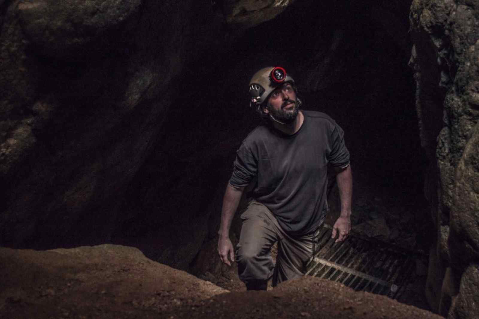 Mine explorer exploring a tin mine in west Cornwall with Cornwall Underground Adventures.